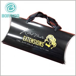 Black hair extensions packaging boxes with bronzing printing. There are black silk belts on the side edges of the pillow boxes to increase the convenience of carrying products.