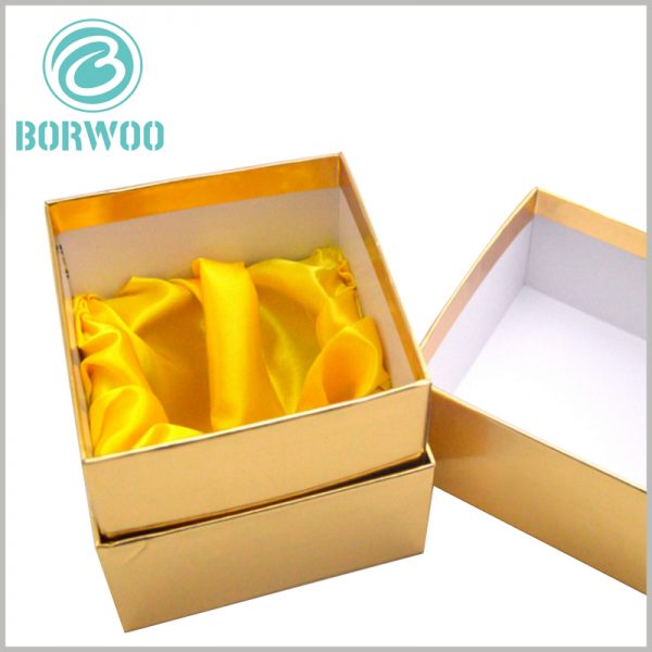 custom gold cardboard boxes for candles. There are inserts inside the custom candle packaging to fix the candle jar, and use yellow silk as the interior decoration.