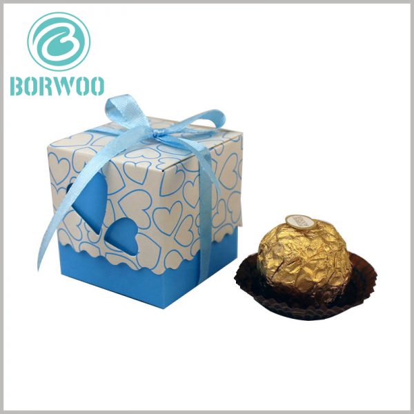 small chocolate gift boxes packaging with gift bows. The square chocolate packaging has a variety of different colors to reflect different flavors of chocolate.