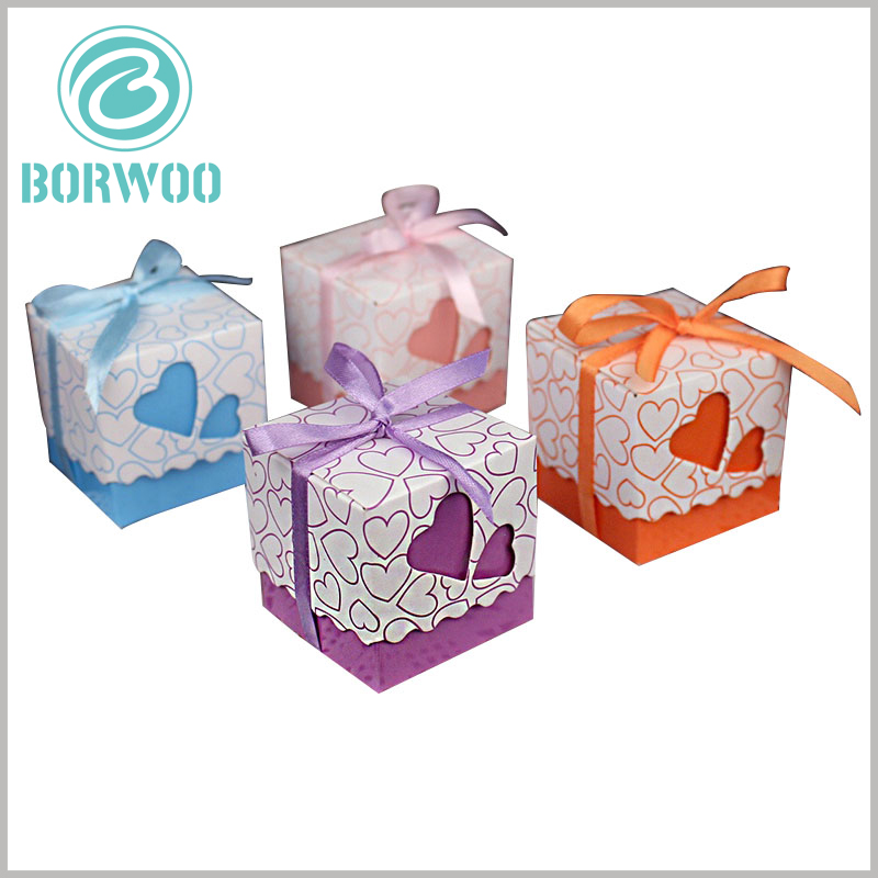 small gift boxes packaging with gift bows. The square cardboard chocolate packaging is designed with different heart-shaped hollow patterns, which give the product more gift value.
