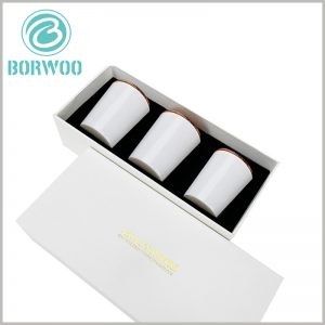white cardboard candle box packaging for 3 jars. The 3 candle jars are arranged neatly inside the package, and the product is presented to consumers in the best form.