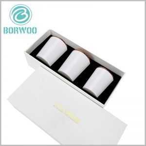 white cardboard candle box packaging for 3 jars. The 3 candle jars are arranged neatly inside the package, and the product is presented to consumers in the best form.